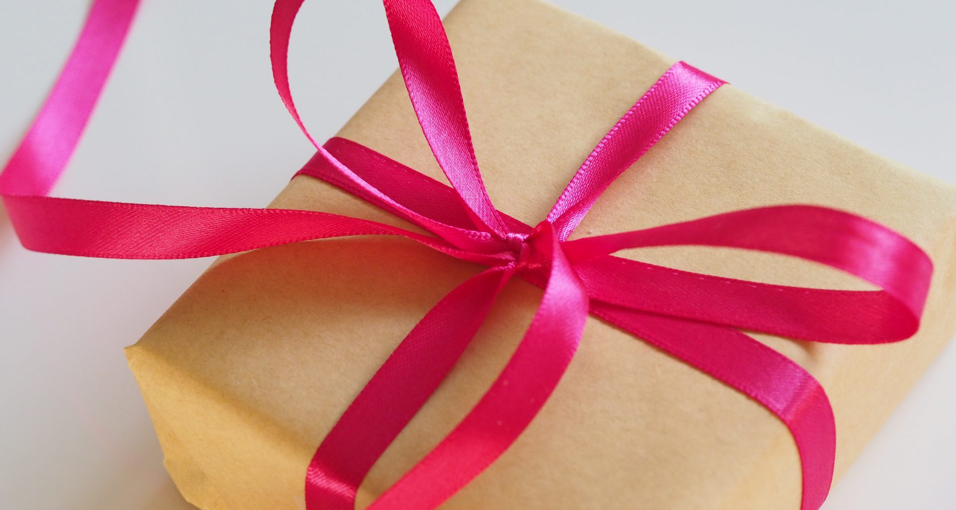 brown gift box with pink ribbon