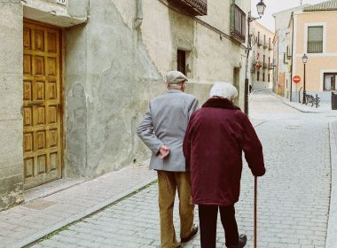 man and woman walking near closed wooden door