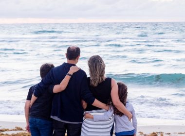 a family of four on a beach