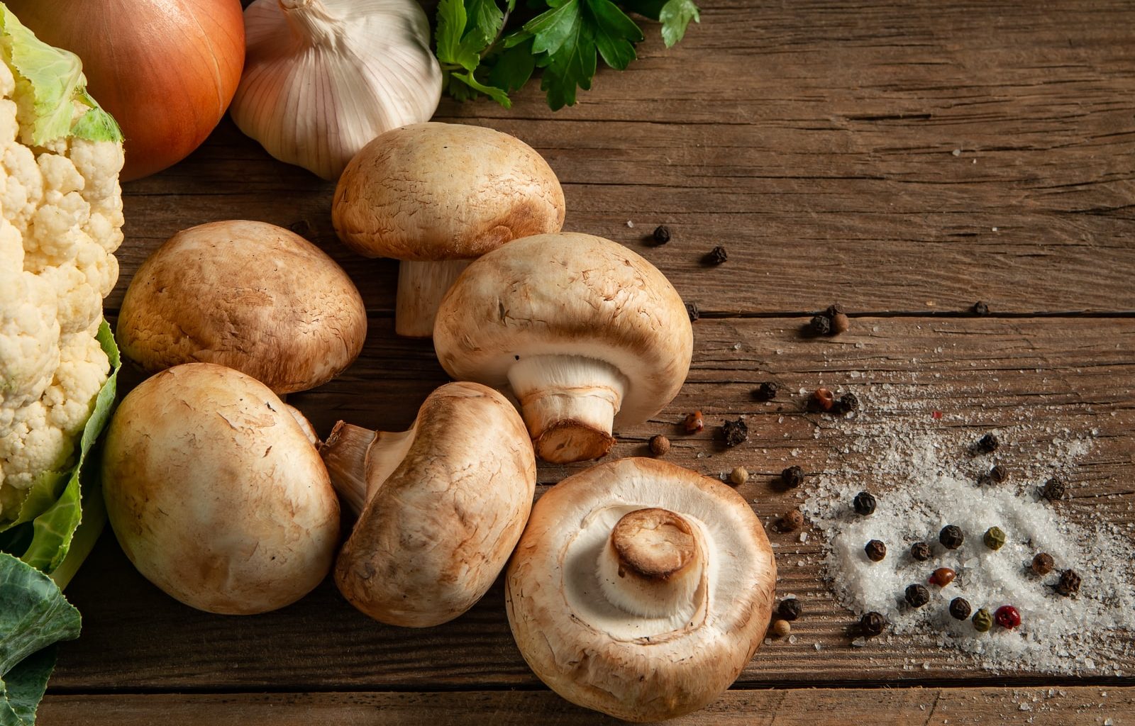 brown mushrooms on gray wooden table