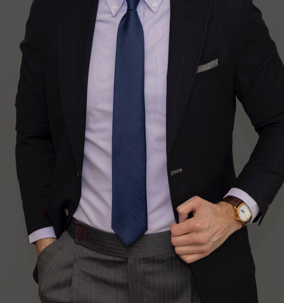 man in black suit jacket and blue necktie
