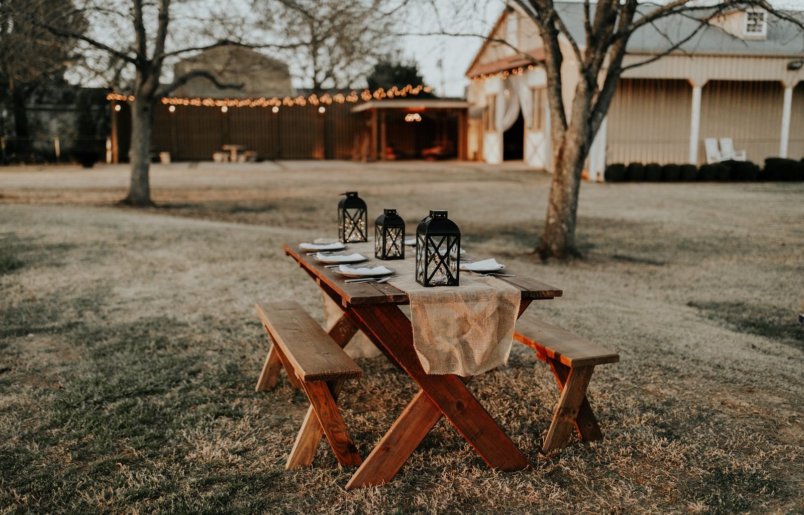 rectangular brown wooden picnic table on the field