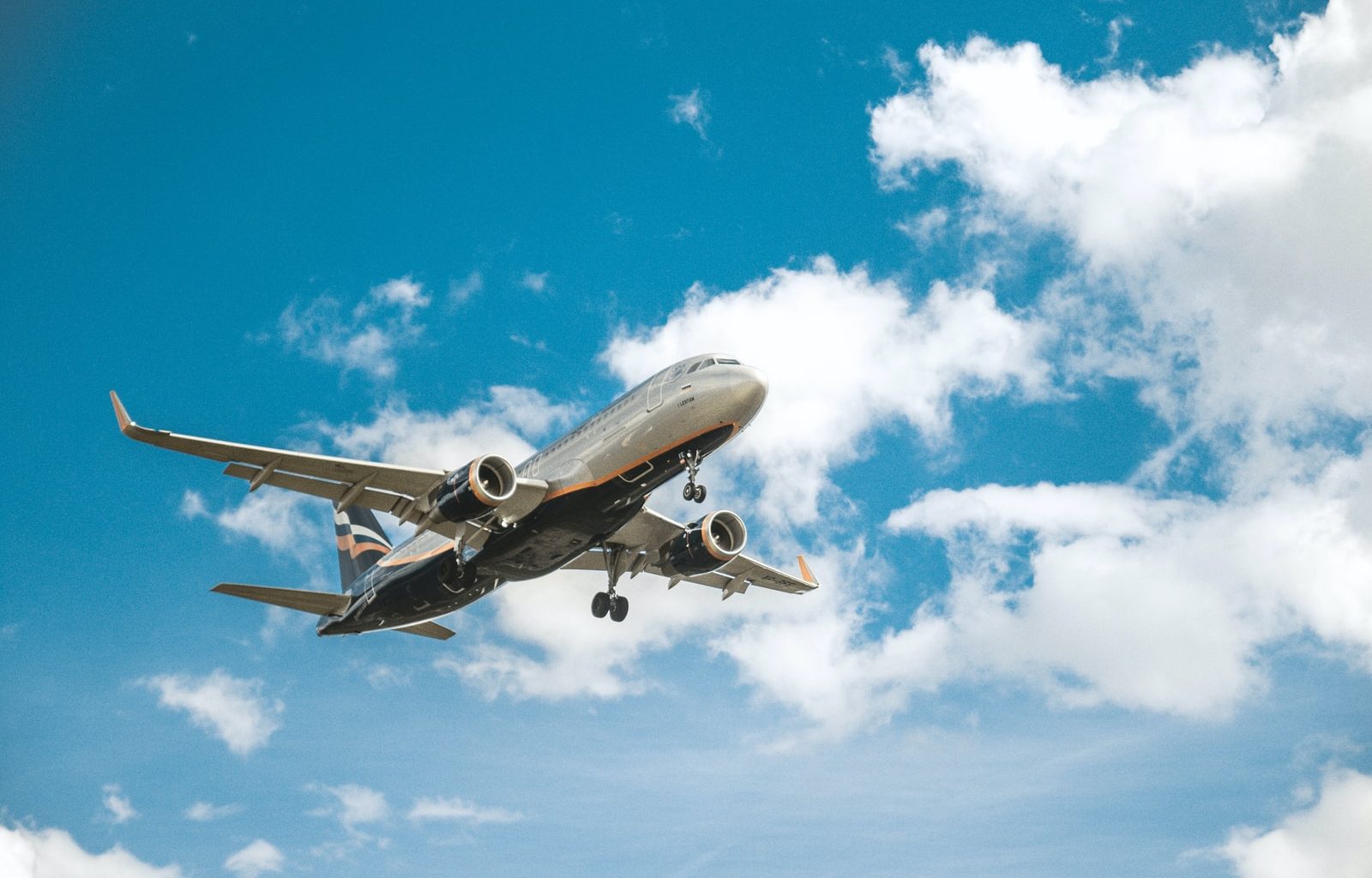 white airplane under blue sky during daytime