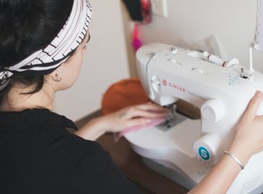 woman in black long sleeve shirt sewing