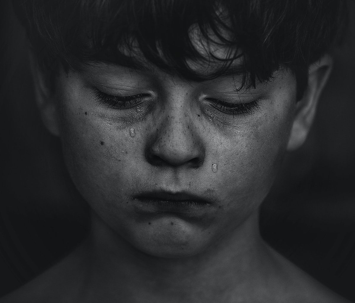 a boy crying tears for his loss