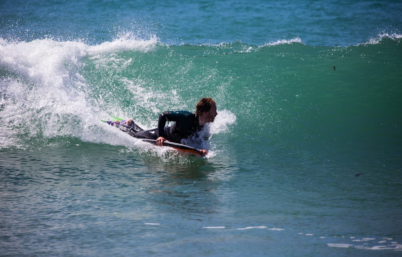 man surfing on sea wave