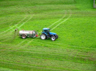 brown tractor on green grass field