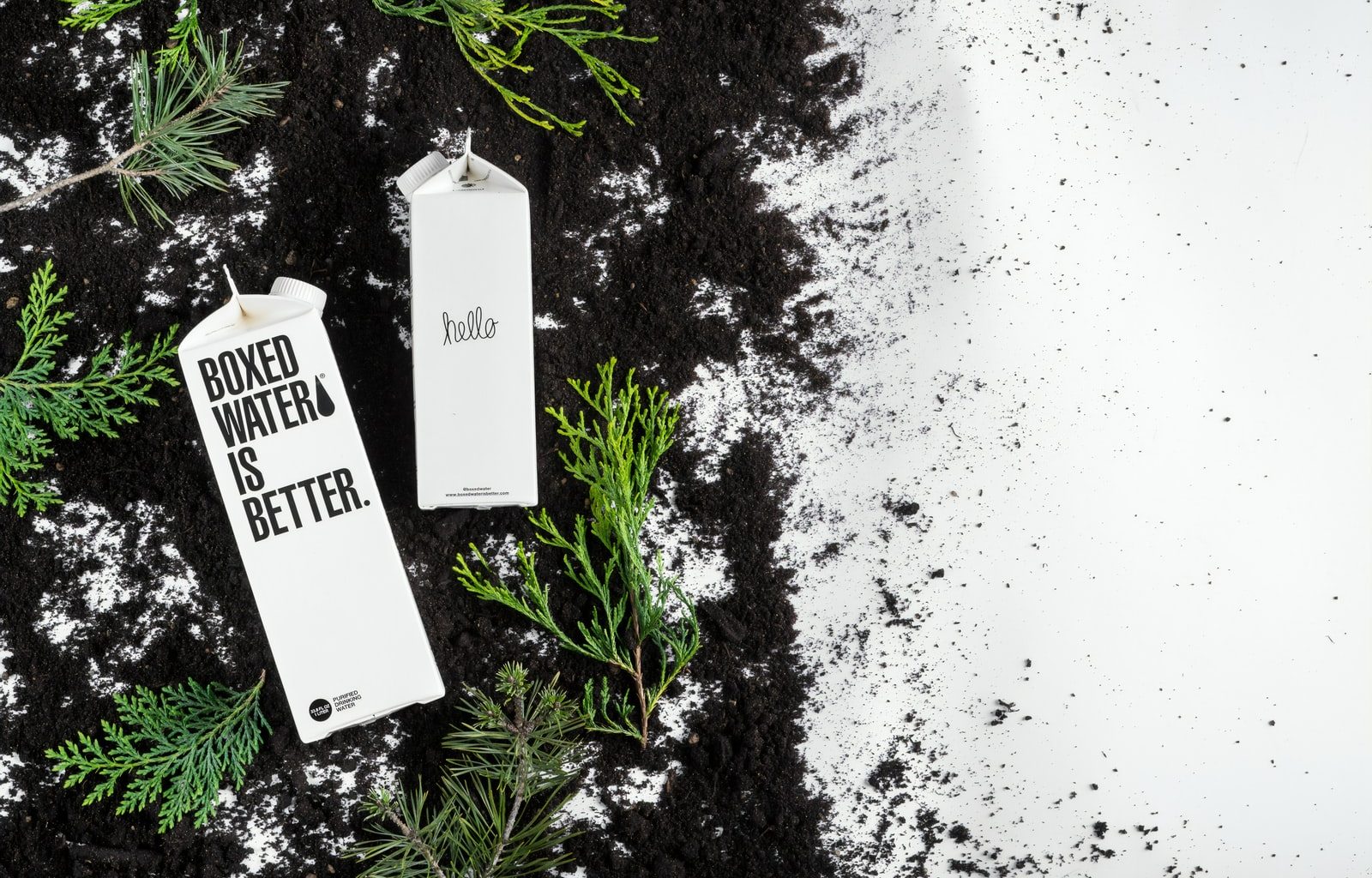 Boxed Water cartons on the black and white ground