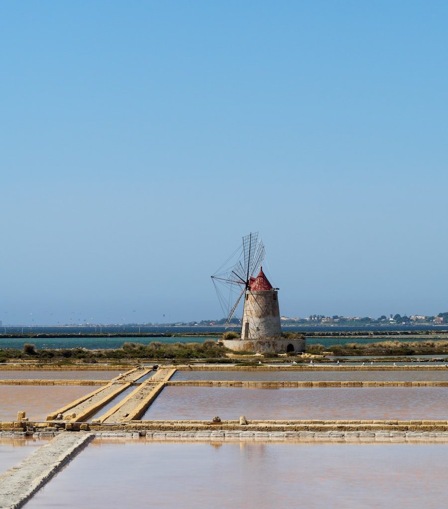 windmill near body of water
