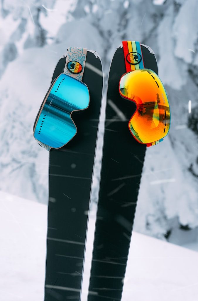 red and yellow snowboard on snow covered ground