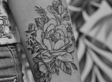 grayscale photo of floral arm tattoo