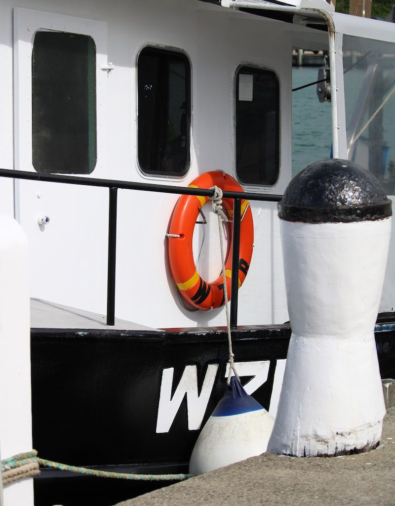 orange and black nike bag on white and black boat