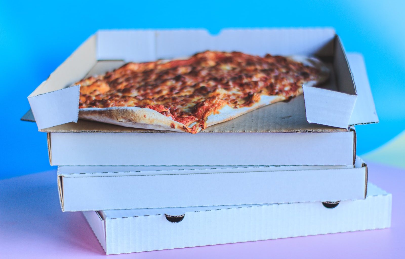 brown and white pizza on white box