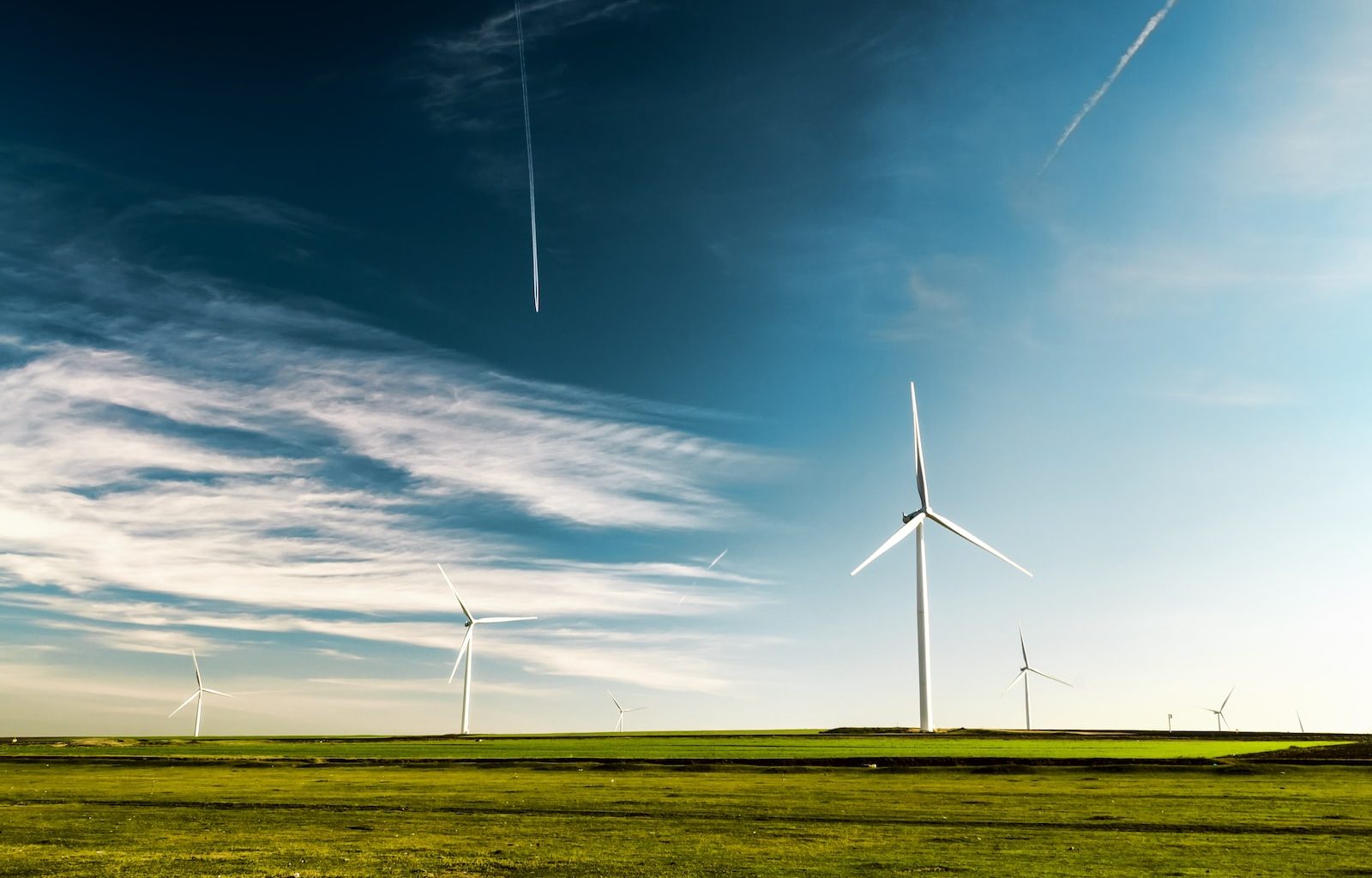 photo of wind turbines on green grass