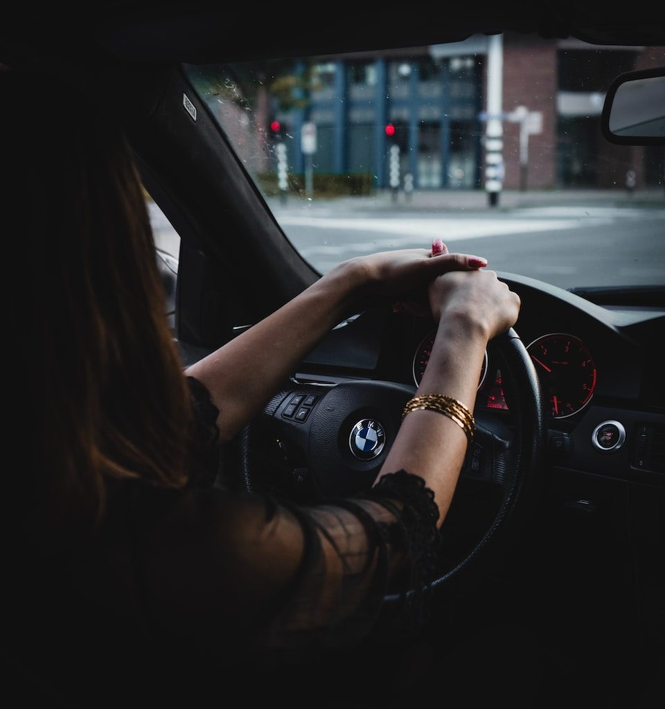woman inside BMW car holding steering wheel