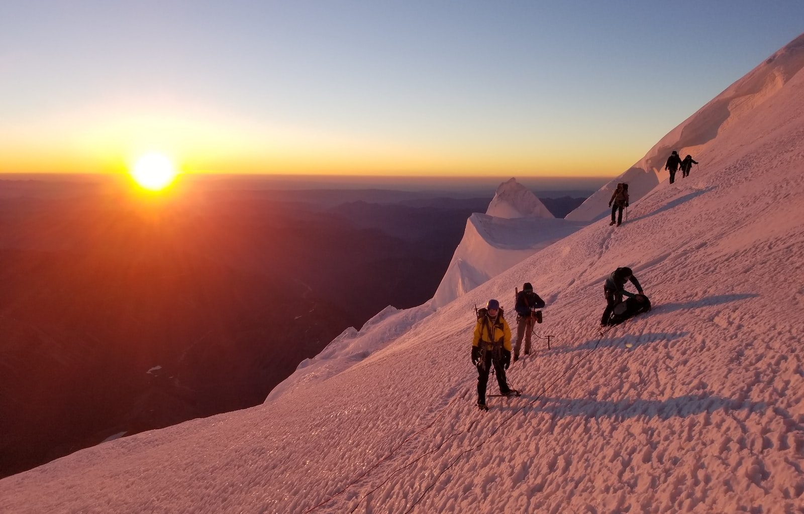 people on glacier mountain during sunset