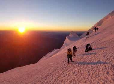 people on glacier mountain during sunset