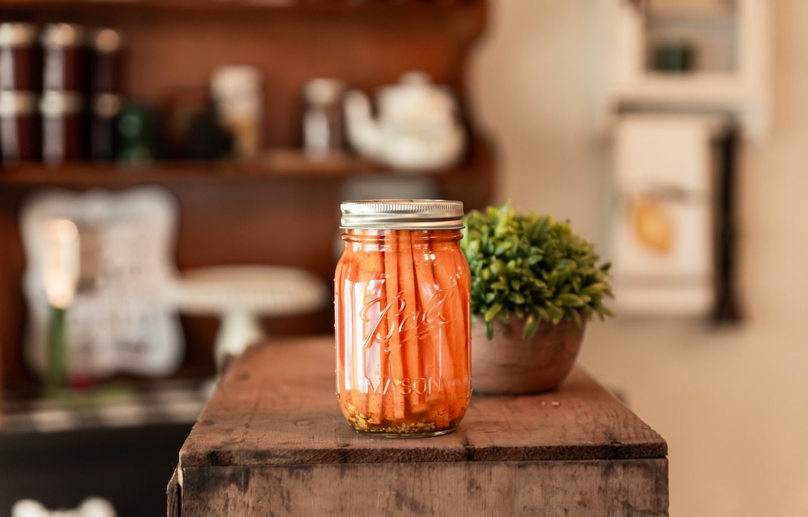 a jar of pickled carrots sitting on a table