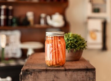 a jar of pickled carrots sitting on a table