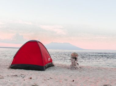 red and black dome tent near seashore