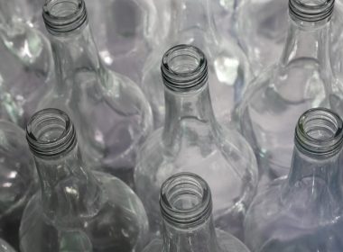 clear glass bottles on brown wooden table